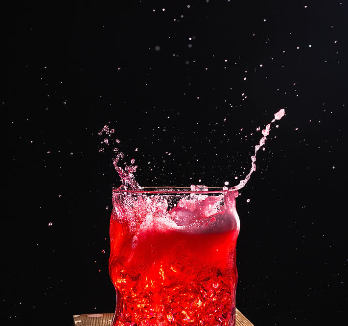 Red liquid in glass exploding out