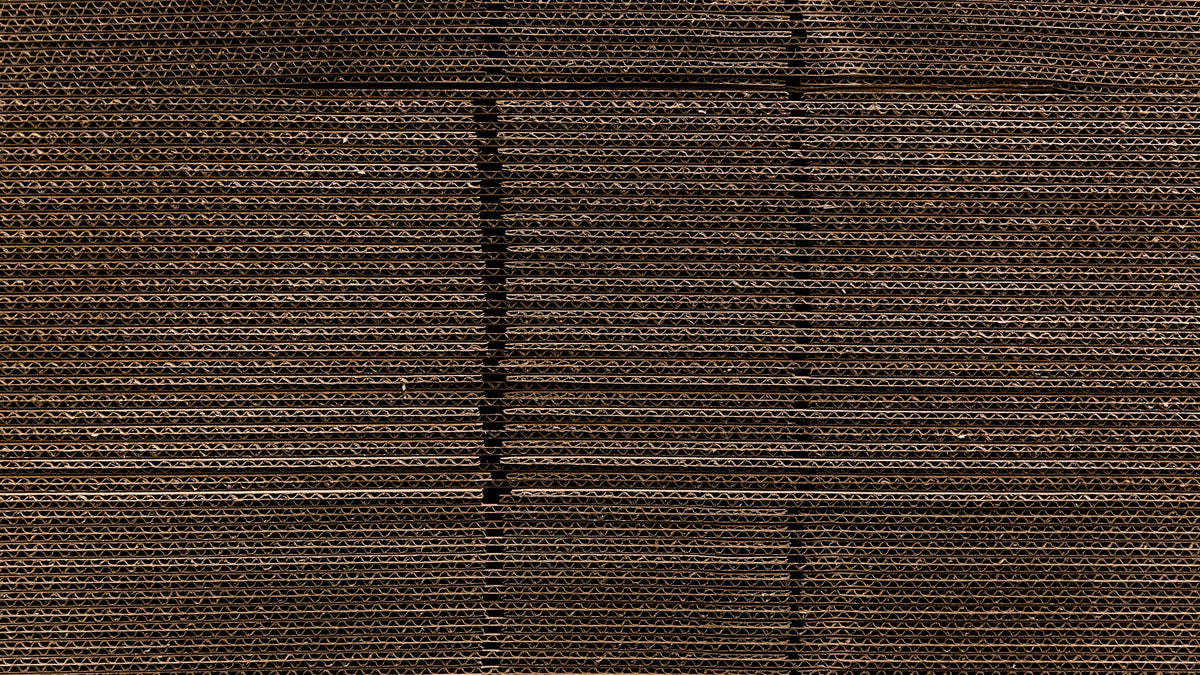 A close-up of a dark brown woven fabric or textured material with horizontal ribbed lines and subtle vertical seam details.